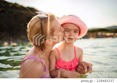 Family joyfully enjoying a summer day at the beach 128485237