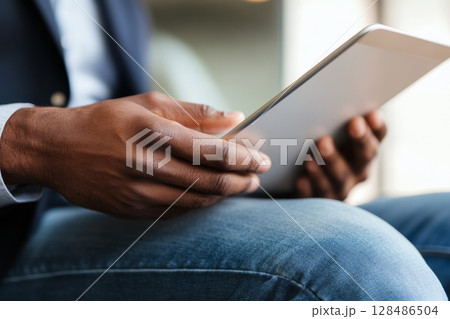 Person using a tablet device. Digital interactions and activities. Man holding a pad. Remote learning, social distance working, ordering buying online, reading e book. Close-Up view, Modern Technology 128486504