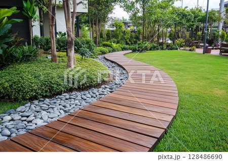 Garden wooden path. Modern garden path way made from hardwood designed with lush greenery, flowers. Wood decking. Backyard pathway walk. Garden lounge. Footpath. Woodland shade. Cottagecore. Outdoor 128486690