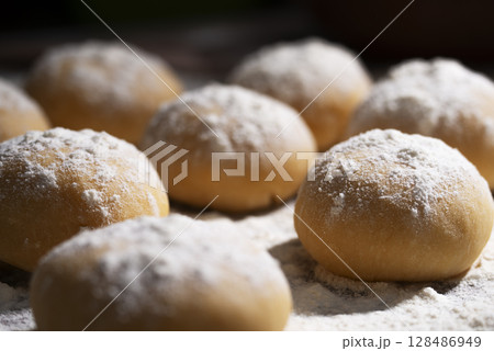 Ball Ready Dough On Floured Kitchen Table low angle view cooking background Ball Ready Dough On Floured Kitchen Table low angle view cooking background 128486949