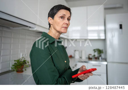Distressed worried woman with smartphone. Mental issues, grief sorrow because of bad internet news Distressed worried woman with smartphone. Mental issues, grief sorrow because of bad internet news 128487445