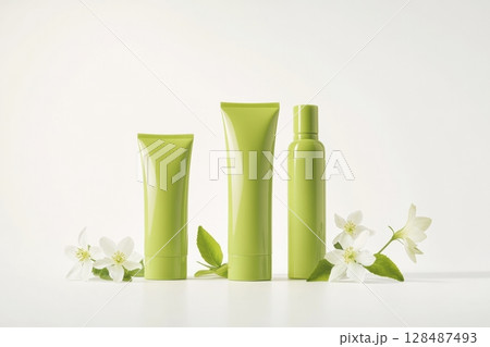 Blank cream tube, jar package plastic set. Pale mint green colors. Skin care luxurious portable on white background, soft shadow. Eco cosmetic containers, flowers. Beauty product modern packaging. 128487493