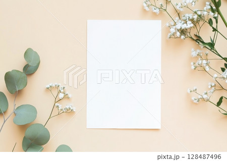 Blank greeting card, invitation mockup. Eucalyptus branch plant on wooden table background. Flat lay, top view. Copy space. Paper sheet mock up. Modern Minimal business brand template. Soft shadow. A4 128487496