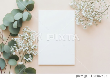 Blank greeting card, invitation mockup. Eucalyptus branch plant on wooden table background. Flat lay, top view. Copy space. Paper sheet mock up. Modern Minimal business brand template. Soft shadow. A4 128487497