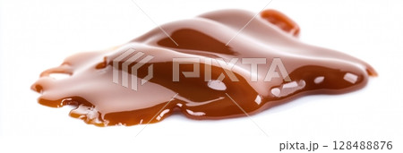 Caramel Isolate. Drops of sweet yellow honey on a white isolated background. Tasty caramel sauce dripping isolated on white background, closeup. Sweet liquid syrup splashing. Melted caramel pouring. 128488876