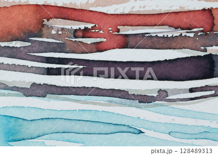 Abstract ink patterns creating a vibrant blend of colors on textured paper in a creative workspace 128489313