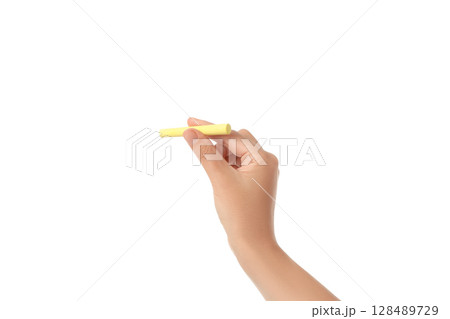 Hand grips yellow chalk for writing or drawing, on white background 128489729