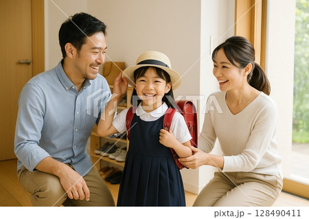 登校前に娘を見送る両親のやさしい朝のひととき 128490411