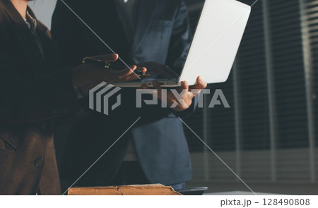 Lawyer explained to the client about the law that must be brought against the court case. Lawyer explained to the client about the law that must be brought against the court case. 128490808