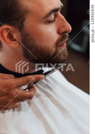 Man is visiting modern barber shop. Modern style Man is visiting modern barber shop. Modern style 128492646