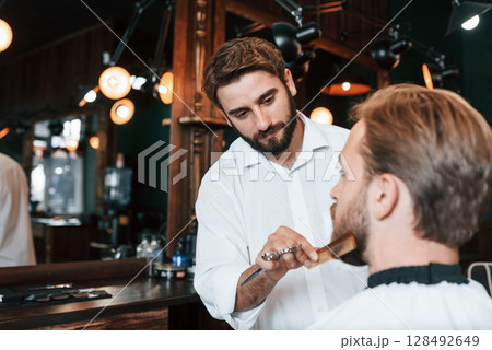 Man is visiting modern barber shop. Modern style 128492649