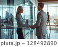 Successful partnership. Business persons shaking hands at the office. 128492890