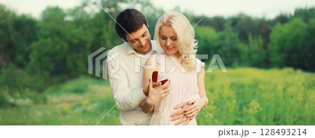 Wedding happy lovely young couple, man proposing a ring to his beloved woman outdoors 128493214