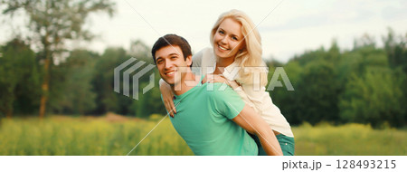 Portrait of beautiful happy smiling young couple in love together hugging in summer park 128493215
