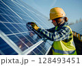 Solar panel technician woman with drill installing solar panels. Generative AI 128493451