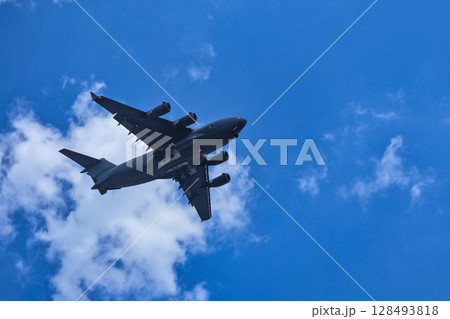 Jet soaring through the clear blue sky. Jet soaring through the clear blue sky. 128493818