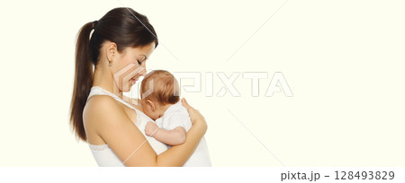 Happy young mother kissing baby on white studio background Happy young mother kissing baby on white studio background 128493829