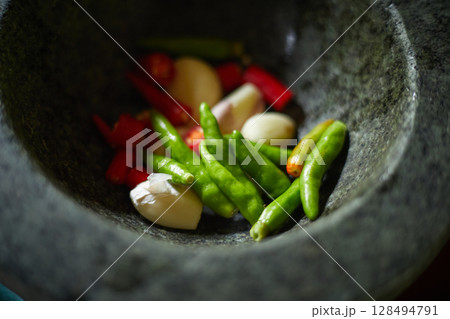 Chilli pepper in stone mortar 128494791