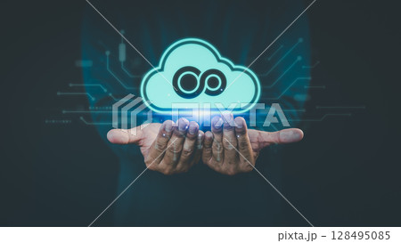 Concept of cloud computing technology, featuring a glowing digital cloud icon floating above a person's hands, with connected circuit lines in the background. Concept of cloud computing technology, featuring a glowing digital cloud icon floating above a person's hands, with connected circuit lines in the background. 128495085