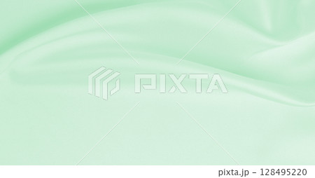 Smooth elegant green silk or satin luxury cloth texture as abstract background. Luxurious background design 128495220