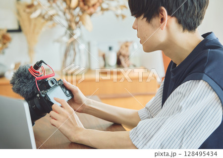 撮影動画をチェックする男性 128495434