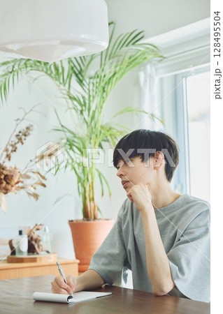 ダイニングでメモをする男性 128495504
