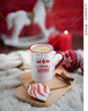 A cup with the inscription Merry Christmas, a cheerful atmosphere, branches of a green Christmas tree. The New Year 2025 is approaching 128495674