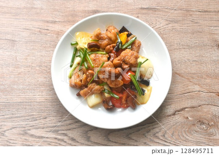 fried slice crispy chicken meat with cashew nut and bell pepper couple onion on plate fried slice crispy chicken meat with cashew nut and bell pepper couple onion on plate 128495711