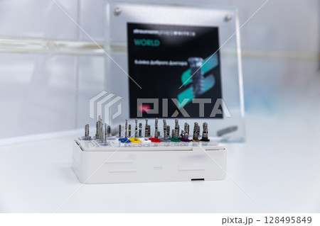 A Close-Up View of a Precision Tool Set Displayed on a White Surface Next to an Information Sign About Innovative Engineering Technology and Component Integration Solutions 128495849