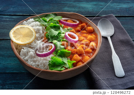 Chana masala, chickpea curry, traditional Indian dish, with fresh cilantro Chana masala, chickpea curry, traditional Indian dish, with fresh cilantro 128496272