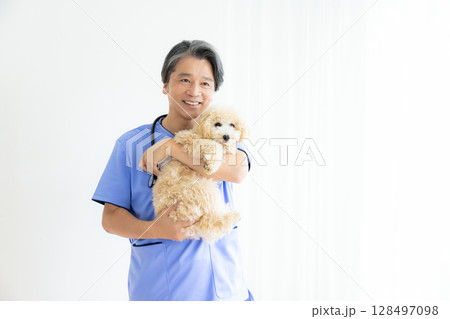 獣医　ビションプーを抱っこしている獣医師のポートレート 128497098