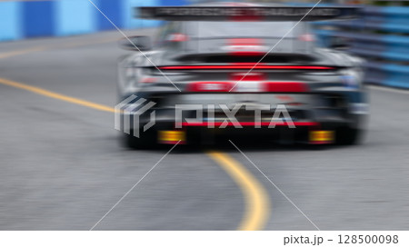Motion blur race car racing on speed track, Motion blurred super car race on street track circuit, Automobile automotive transportation vehicle background, 128500098
