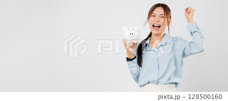 Piggy bank and happy woman excited holding money with piggy save success and showing win mindset toward personal investment and banking. isolated studio white background Piggy bank and happy woman excited holding money with piggy save success and showing win mindset toward personal investment and banking. isolated studio white background 128500160