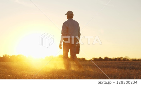 Farmer walking through wheat field in rubber boots, , agriculture, business of the golden grain, farmer s life: a wheat story, sowing seeds of success, the art of wheat harvesting, farmer's autumn 128500234