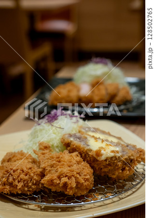 Cheese tonkatsu pork cutlet with shredded cabbage served on plate Cheese tonkatsu pork cutlet with shredded cabbage served on plate 128502765