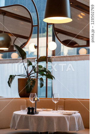 Set up table with spoon, fork, knife and plate with wine glass in the restaurant Set up table with spoon, fork, knife and plate with wine glass in the restaurant 128502769