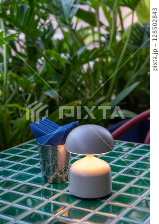 Table lamp with tissue paper on the table, in fine dining restaurant Table lamp with tissue paper on the table, in fine dining restaurant 128502843