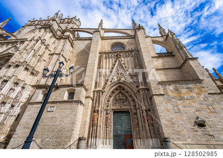 Sevilla Cathedral Grand Gothic Entrance with Blue Sky Background. 128502985