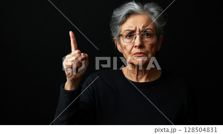 senior woman with finger up disapproving expression 128504831