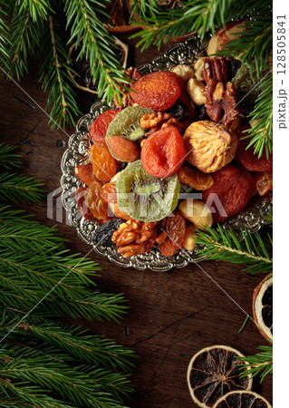 Assorted dried fruits and nuts on a silver tray. Assorted dried fruits and nuts on a silver tray. 128505841