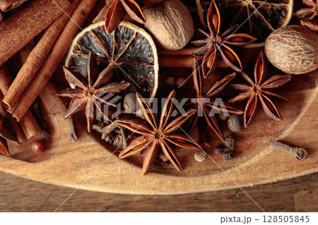 Various Christmas spices with dried citrus slices. Various Christmas spices with dried citrus slices. 128505845