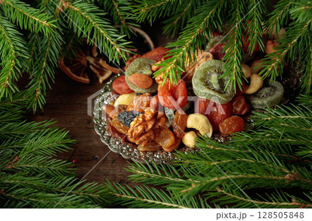 Assorted dried fruits and nuts on a silver tray. Assorted dried fruits and nuts on a silver tray. 128505848