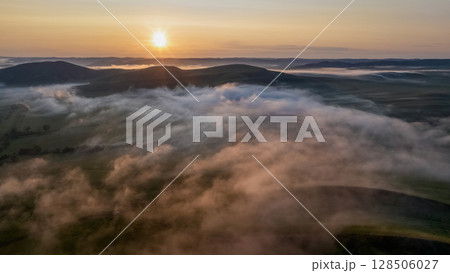 sun rises over a picturesque mountain valley 128506027