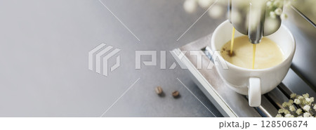 Coffee machine makes espresso. Professional coffee brewing. Cup of fresh hot espresso with coffee beans on grey natural background with flower. Coffee break. Romantic morning. Banner size, copy space Coffee machine makes espresso. Professional coffee brewing. Cup of fresh hot espresso with coffee beans on grey natural background with flower. Coffee break. Romantic morning. Banner size, copy space 128506874