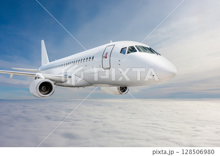 White passenger jetliner fly in the air above the clouds 128506980