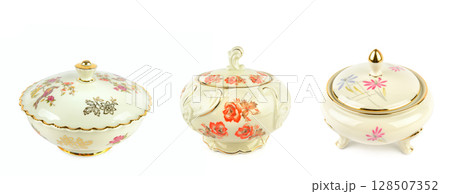 Set of porcelain vintage sugar bowls and candy bowls isolated on white background. 128507352