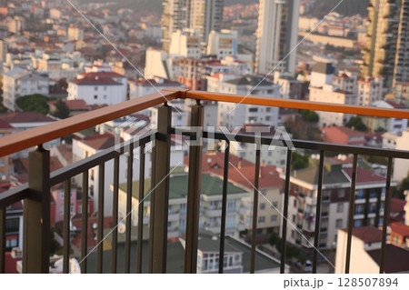 Take in the stunning Urban Landscape View from the Balcony Overlooking a Bustling Cityscape Take in the stunning Urban Landscape View from the Balcony Overlooking a Bustling Cityscape 128507894