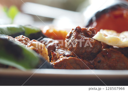 Grilled meat and vegetables on a plate at a summer gathering Grilled meat and vegetables on a plate at a summer gathering 128507966