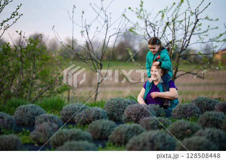 Grandmother and granddaughter enjoying a moment together in a lavender field. 128508448