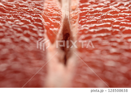 Detailed close-up photo of juicy red grapefruit slices. Macro photo of citrus fruits 128508638